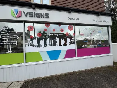 VSigns window graphics of poppies and marching soldiers reading Lest we forget