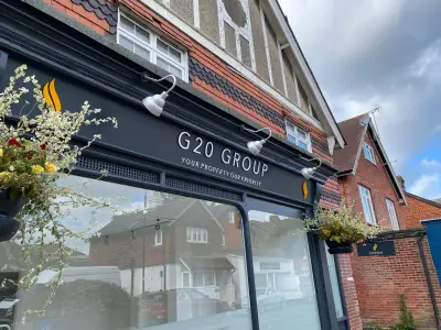 G20 Group estate agent shopfront fascia sign reading Your Property Our Priority