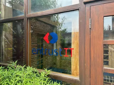entrust IT logo window graphic applied to a timber-framed office window
